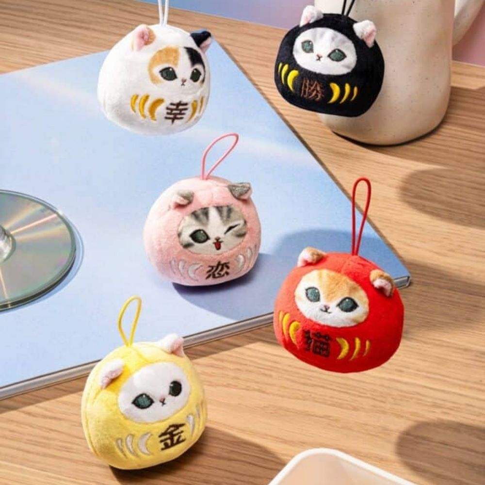 Officially licensed Mofusand Daruma Nyan Plush Keychain Blind Box showing round plush cats in colorful Daruma doll suits alongside a fortune paper slip