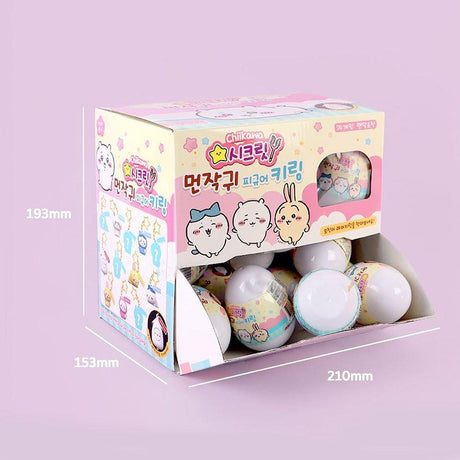 Box of small round toys with Officially licensed by Chiikawa characters on a light purple background