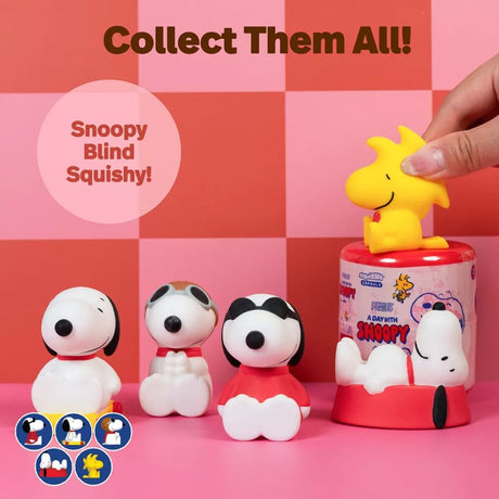 Officially licensed Peanuts Snoopy and Woodstock Squishu water-filled squishy figures in various poses displayed alongside a red surprise capsule