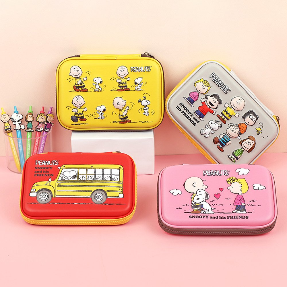 Officially licensed Peanuts hard shell pencil cases in yellow, red, pink, and grey featuring Snoopy, Charlie Brown, and friends
