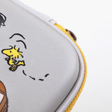 Officially licensed Peanuts hard shell pencil cases in yellow, red, pink, and grey featuring Snoopy, Charlie Brown, and friends