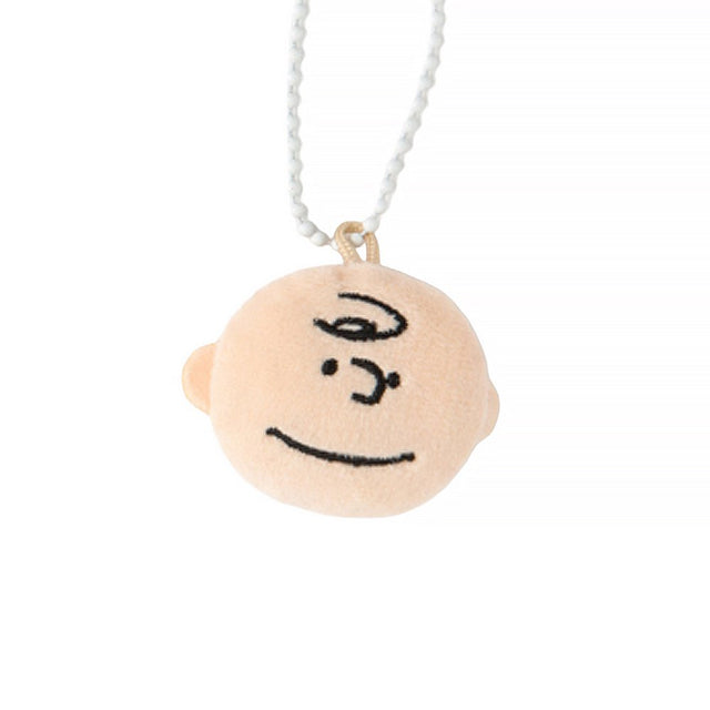 Officially licensed Peanuts plush keychain featuring the face of Charlie Brown attached to a white ball chain.