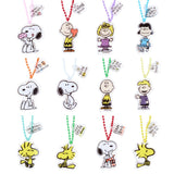 A collection of 12 different Peanuts character acrylic keychains in "Luck For You" blind boxes. The keychains feature Snoopy, Woodstock, Charlie Brown, Lucy, Linus, and Sally.