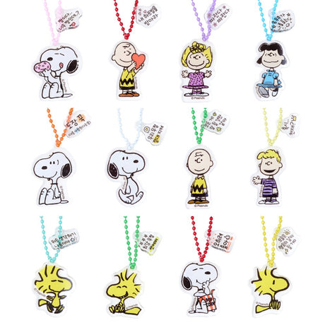 A collection of 12 different Peanuts character acrylic keychains in "Luck For You" blind boxes. The keychains feature Snoopy, Woodstock, Charlie Brown, Lucy, Linus, and Sally.
