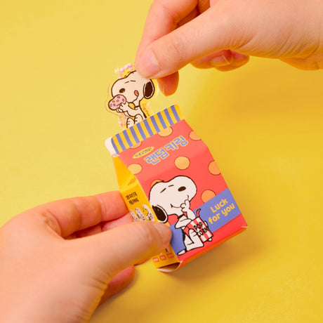 A collection of 12 different Peanuts character acrylic keychains in "Luck For You" blind boxes. The keychains feature Snoopy, Woodstock, Charlie Brown, Lucy, Linus, and Sally.