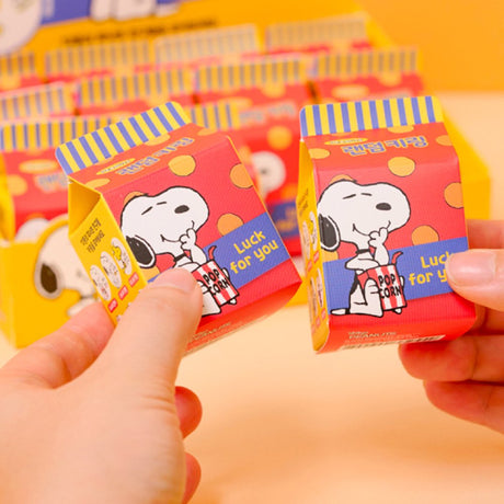 A collection of 12 different Peanuts character acrylic keychains in "Luck For You" blind boxes. The keychains feature Snoopy, Woodstock, Charlie Brown, Lucy, Linus, and Sally.