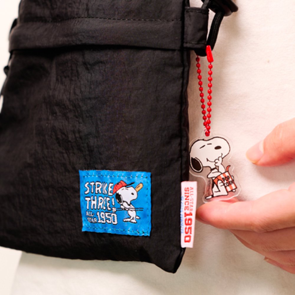 A collection of 12 different Peanuts character acrylic keychains in "Luck For You" blind boxes. The keychain features Snoopy.