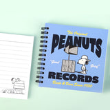 An overhead shot showing officially licensed Peanuts spiral notebook in blue, showcasing the different vintage-inspired cover design and black spiral binding.