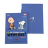 Two officially licensed Peanuts notebooks in red and blue featuring Snoopy and Charlie Brown. The image demonstrates the unique "wing" cover flaps being used as bookmarks and page markers within the lined journal pages.