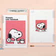 Three officially licensed Peanuts line notebooks with translucent covers in soft hues of pink, yellow, and green, each featuring a large illustration of Snoopy. The interior view shows 8mm ruled pages with small Snoopy graphics at the top and bottom corners.
