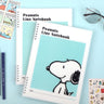 Three officially licensed Peanuts line notebooks with translucent covers in soft hues of pink, yellow, and green, each featuring a large illustration of Snoopy. The interior view shows 8mm ruled pages with small Snoopy graphics at the top and bottom corners.

