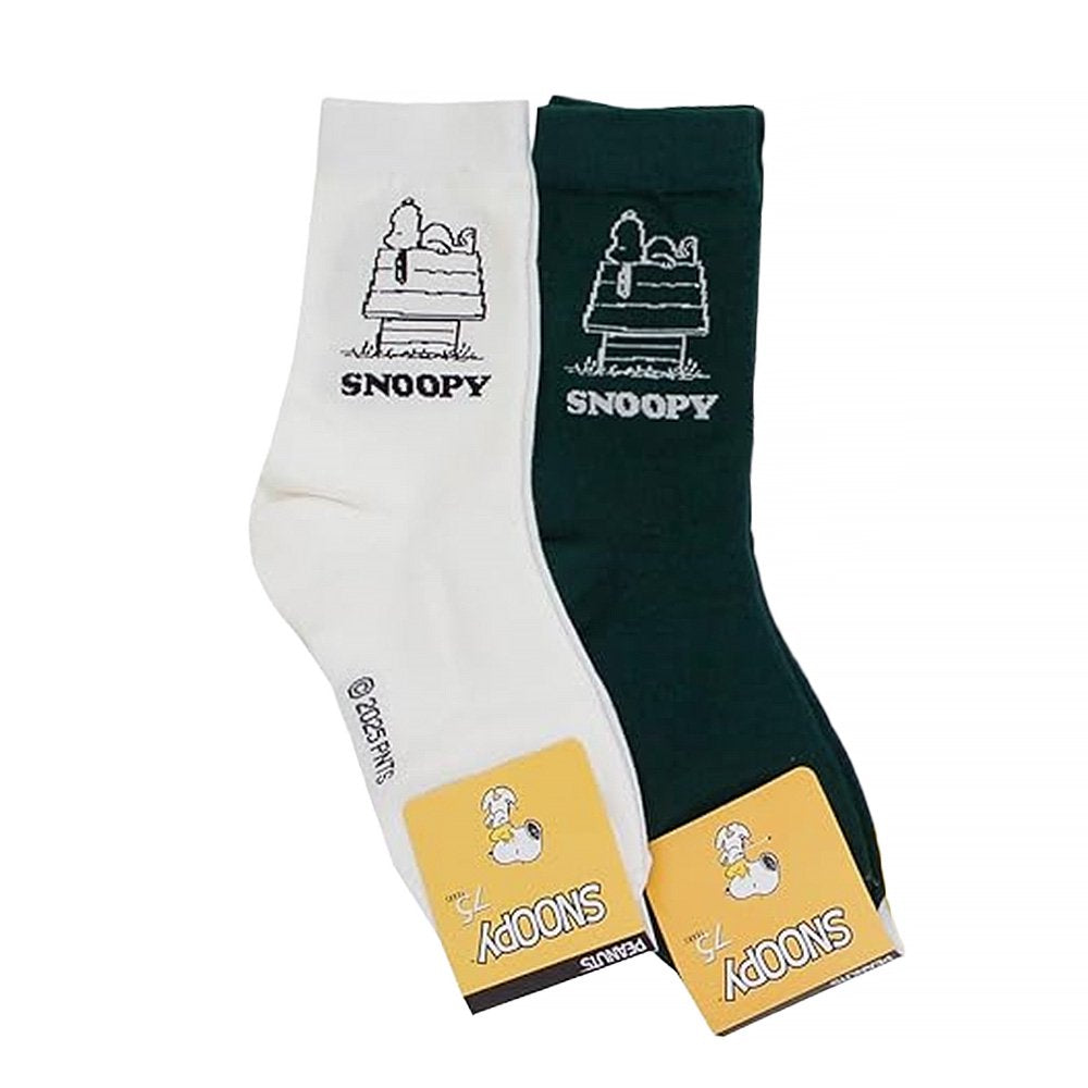 A pair of crew-length socks in white and green. Both feature a white embroidered graphic of Snoopy sleeping on top of his doghouse with "SNOOPY" text below.