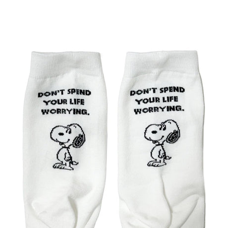 A set of three crew-length socks in white, beige, and black, celebrating Snoopy's 75th anniversary. Features clean, line-art illustrations of Snoopy and Woodstock in their most recognizable poses.