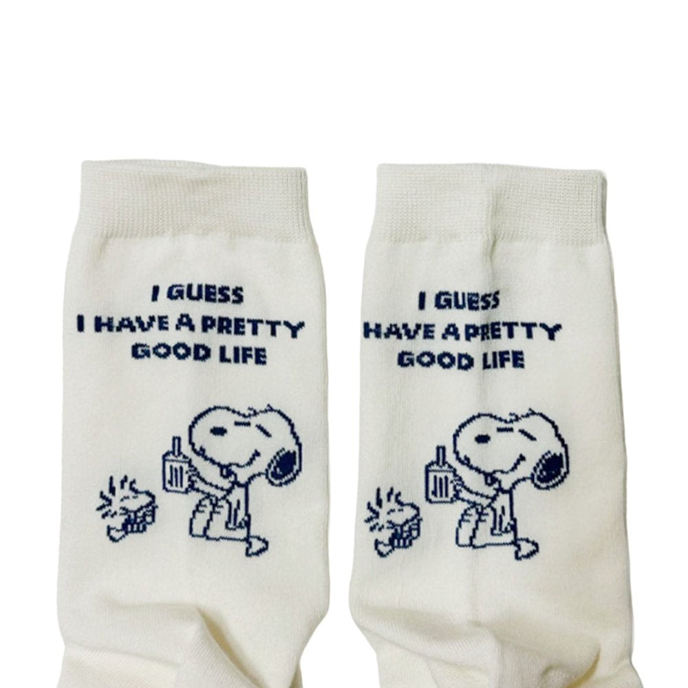 A set of three crew-length socks in white, beige, and black, celebrating Snoopy's 75th anniversary. Features clean, line-art illustrations of Snoopy and Woodstock in their most recognizable poses.