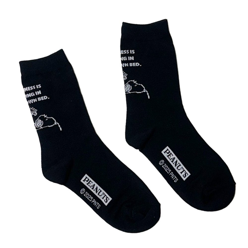 A set of three crew-length socks in white, beige, and black, celebrating Snoopy's 75th anniversary. Features clean, line-art illustrations of Snoopy and Woodstock in their most recognizable poses.