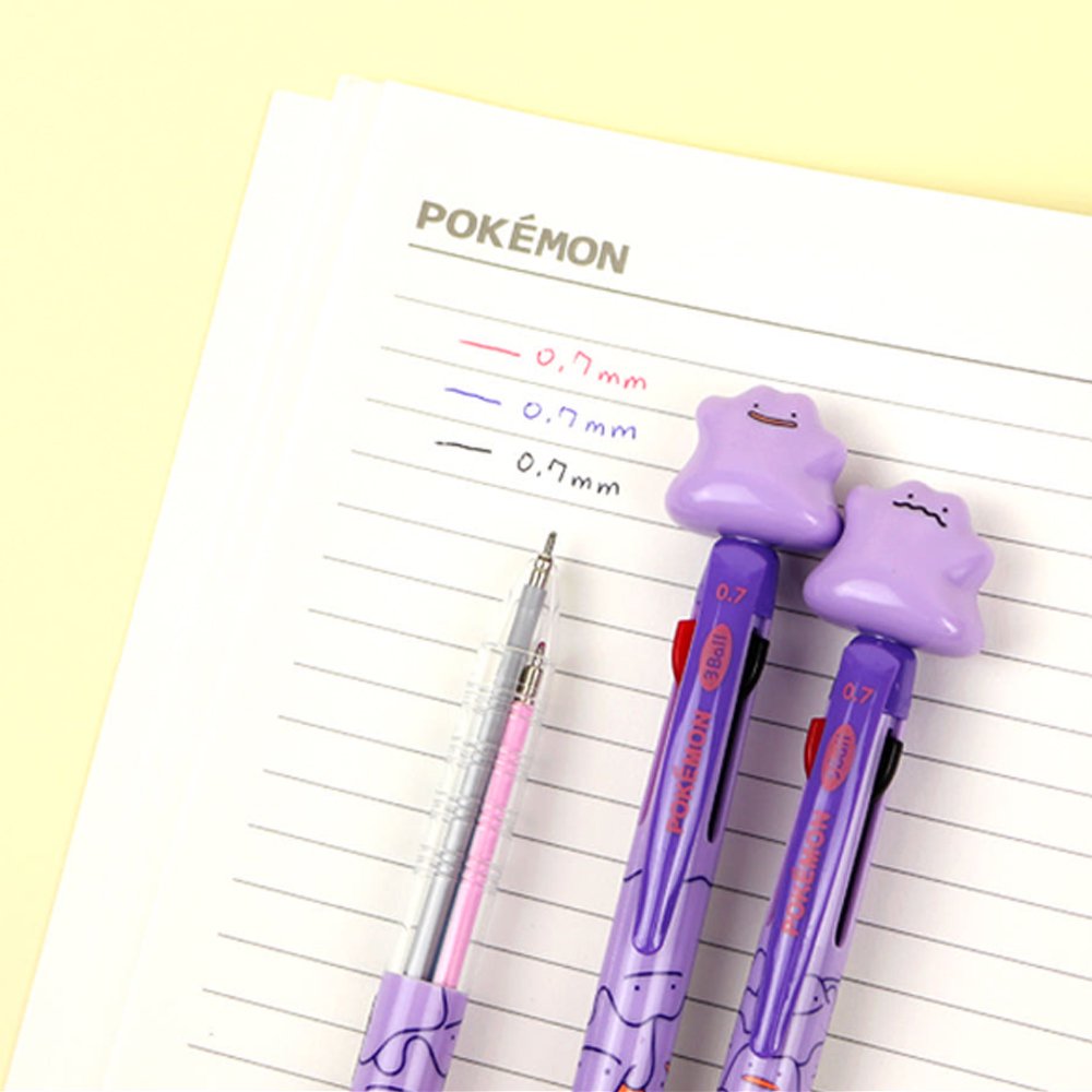 An officially licensed purple Pokemon 3-color ballpoint pens featuring a 3D Ditto character topper and a 0.7mm tip, decorated with various Ditto expressions on the barrel.
