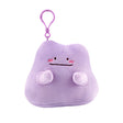 An officially licensed Pokémon Ditto plush clip-on keychain in a vibrant light purple color. The plush features a simple smile, and three pink diagonal lines on each cheek to represent blushing.