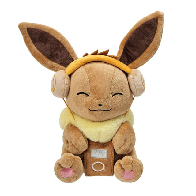 An officially licensed Pokemon Eevee plush toy wearing tan headphones and holding a brown plush music player, featuring a happy, closed-eye expression