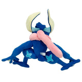 An officially licensed Pokemon Greninja plush toy in a dynamic crouching ninja pose, featuring a deep blue body, cream-colored underbelly, and a soft pink plush tongue wrapped around its neck like a scarf