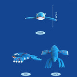 A large, horizontal plush of the Legendary Pokémon Kyogre. The plush is vibrant blue with white oval patches on its head and large, flat flippers featuring red circular patterns and white finger-like tips. It has small yellow eyes and a sleek, aerodynamic body shape.