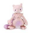 Pokemon Mewtwo plush doll with pink body, purple accents, and intense gaze, seen against a white backdrop