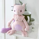 A soft plush toy of the Pokémon Mewtwo, featuring its light purple body, darker purple belly, and long tail, standing upright on a white background