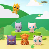 Officially licensed Pokemon Palmsize Wonders Vol. 3 Poke Ball mystery capsules arranged in a display box alongside stylized mini figures of Gengar, Dragonite, Mew, Mewtwo, Vulpix, and Jigglypuff