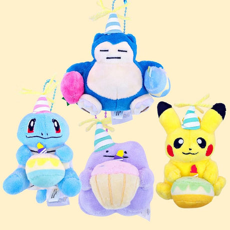 A group of four Pokémon plush keychains including Snorlax, Squirtle, Ditto, and Pikachu. Each wears a teal or pink striped party hat with yellow yarn on top. Snorlax holds pink and blue balloons; Squirtle and Pikachu hold small birthday cakes with candles; and Ditto holds a large pink-frosted cupcake with a candle. They are attached to colorful ball chains.