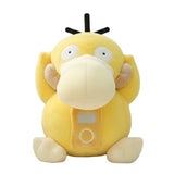 An officially licensed Psyduck plush sitting upright with its hands on its head, wearing a plush headset with a plush music player on its chest
