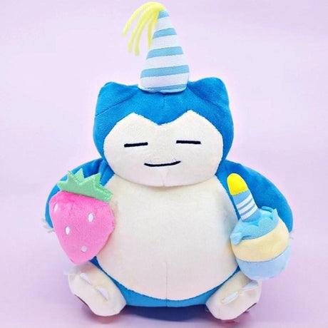 Officially licensed Pokemon plush Snorlax wears a charming party hat topped with a bright yellow tassel, and holing a cake for celebrating a special day
