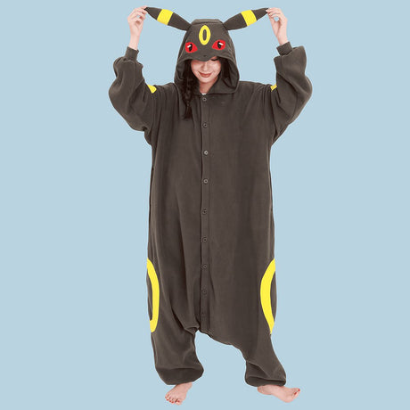 Official Pokémon Umbreon Costume Kigurumi Onesie Jumpsuit worn by a model holding the hooded ears. Features a soft black fleece body with yellow oval patterns and red character eyes. An ideal cosplay outfit for Halloween costumes, cozy sleepover nights, and year-end holiday party loungewear for adult Pokémon fans.