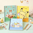 Three pastel-colored Pokemon Pokepeace spiral notebooks showcase adorable illustrations of Pikachu, Scorbunny, and other characters alongside cakes and sweets on green, yellow, and blue covers.
