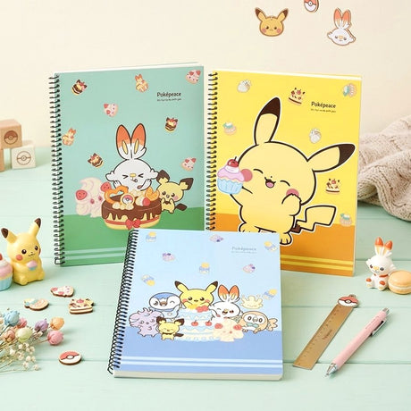 Three pastel-colored Pokemon Pokepeace spiral notebooks showcase adorable illustrations of Pikachu, Scorbunny, and other characters alongside cakes and sweets on green, yellow, and blue covers.
