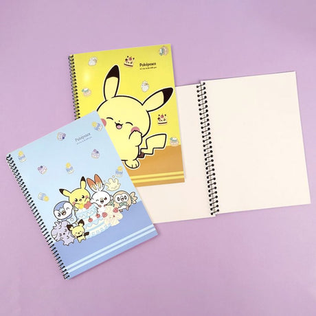 Three pastel-colored Pokemon Pokepeace spiral notebooks showcase adorable illustrations of Pikachu, Scorbunny, and other characters alongside cakes and sweets on green, yellow, and blue covers.
