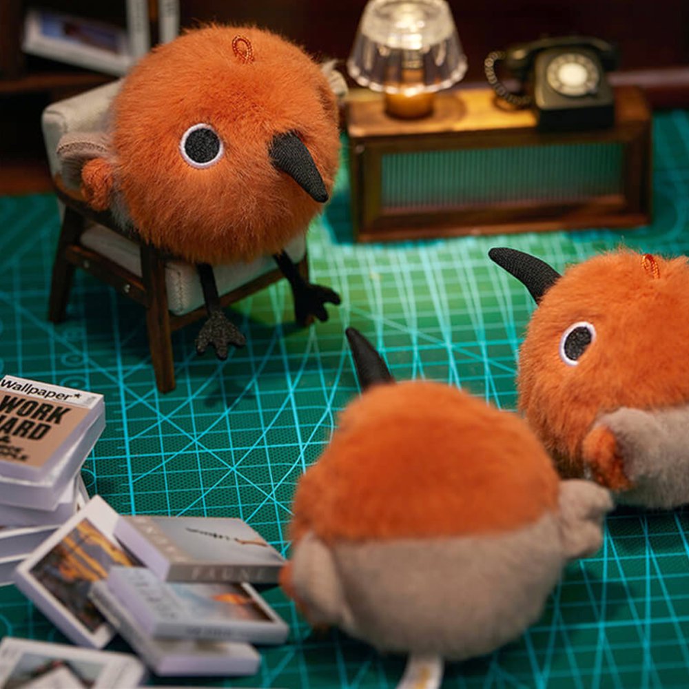 A round, fluffy Asian Dowitcher bird plush keychain with bright orange and tan fur, a black beak, and small black feet