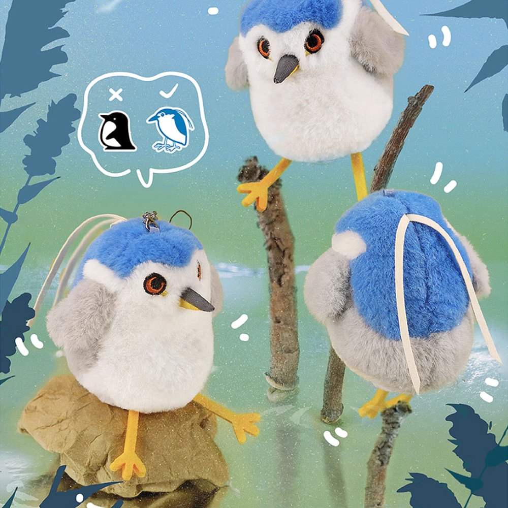 A round, fluffy white Black-crowned Night Heron bird plush keychain with a bright blue crown, grey wings, and long yellow feet
