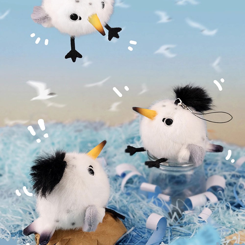 A round, fluffy white Chinese Crested Tern bird plush keychain with a spiky black crest, speckled body details, and a yellow-tipped beak