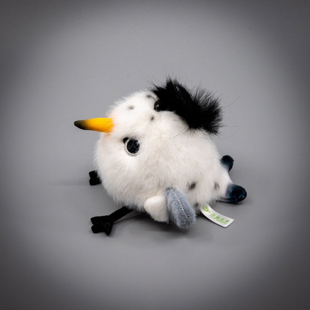 A round, fluffy white Chinese Crested Tern bird plush keychain with a spiky black crest, speckled body details, and a yellow-tipped beak