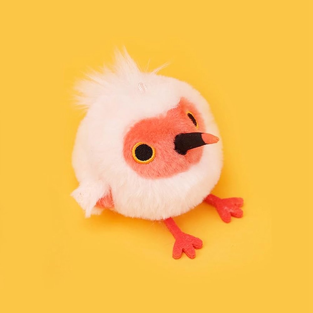 A round, light pink Crested Ibis bird plush keychain with a bright red face, red feet, and a wispy white crest
