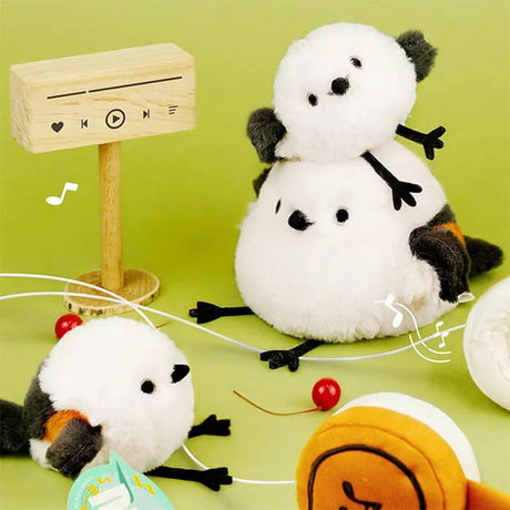 A small, round white Long-tailed Tit bird plush keychain with dark grey wings and tiny black eyes