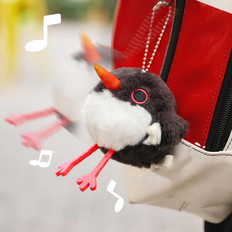 A round, black and white Oystercatcher bird plush keychain with a bright orange beak and pink feet, featuring red-rimmed eyes
