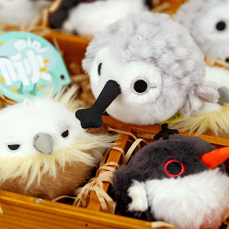 A round, black and white Oystercatcher bird plush keychain with a bright orange beak and pink feet, featuring red-rimmed eyes