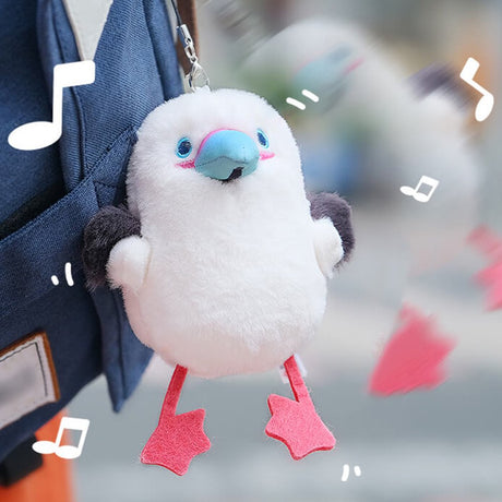 A round, fluffy white Red-footed Booby bird plush keychain featuring grey wings, a blue beak, and bright pink webbed feet