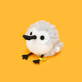A round, fluffy white and grey Sandpiper bird plush keychain with a black spoon-shaped beak and small black feet