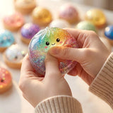 Six colorful, glittery Rainbow Mystery Squishy dumpling toys with cute cartoon faces sit inside mini plastic bun steamer baskets