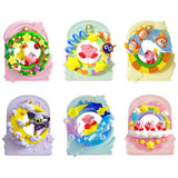 Officially licensed Kirby Manmaru Loop Re-Ment blind box set featuring a pink rainbow loop Kirby figure alongside the full display box and six collectible loop dioramas