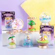 A collection of six different officially licensed Kirby terrarium figures. The miniatures feature Kirby in various settings like a snowy landscape, a tropical island, and napping on a tree stump, all enclosed in clear jars or globes.