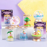 A collection of six different officially licensed Kirby terrarium figures. The miniatures feature Kirby in various settings like a snowy landscape, a tropical island, and napping on a tree stump, all enclosed in clear jars or globes.