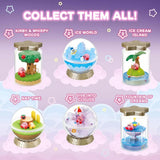 A collection of six different officially licensed Kirby terrarium figures. The miniatures feature Kirby in various settings like a snowy landscape, a tropical island, and napping on a tree stump, all enclosed in clear jars or globes.