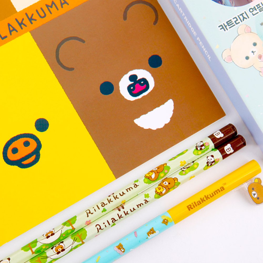 Two officially licensed Rilakkuma and Chairoikoguma stationery sets in clear plastic carry cases with handles. Both cases are packed with notebooks, pencils, and other stationery items.